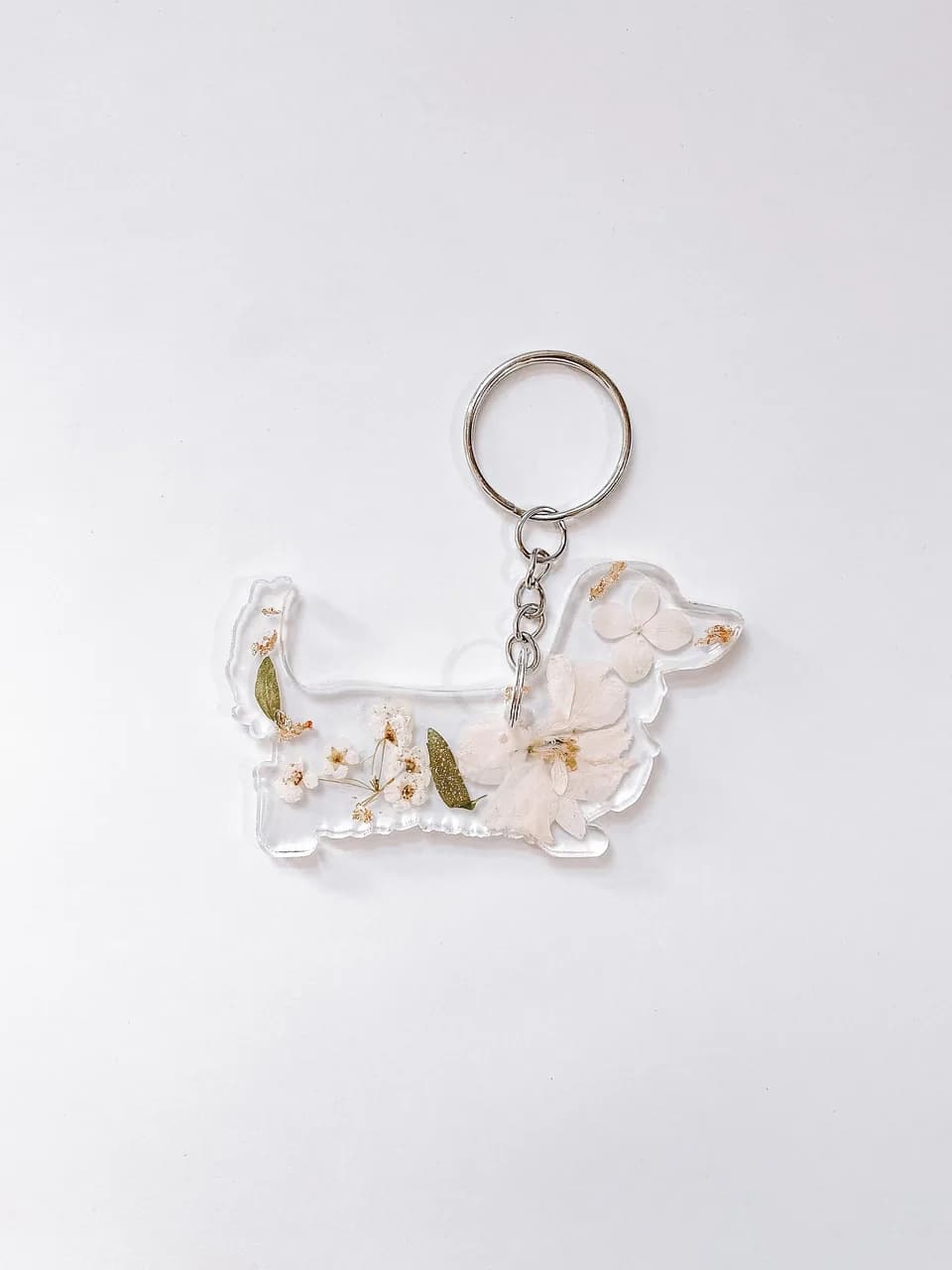 Long haired dachshund resin keychain with white pressed flowers