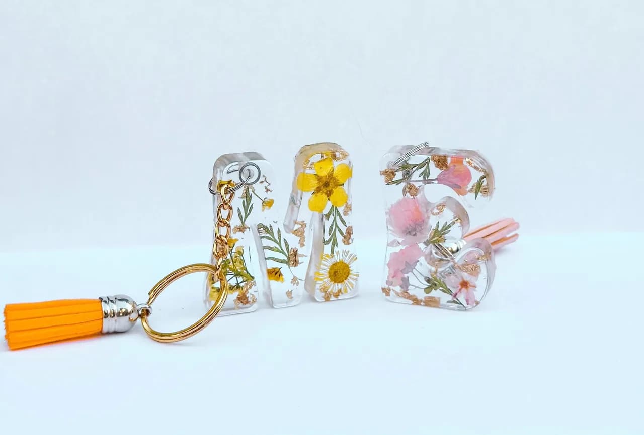 Custom resin letter keychains with dried flowers and gold foil